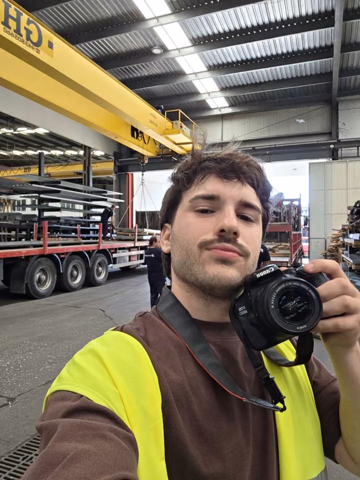 Juan Torralbo holding a camera in an industrial setting